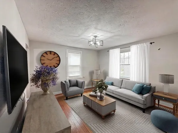 a living room with furniture and a chandelier