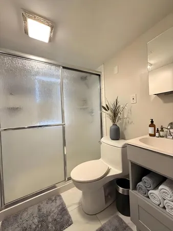 a bathroom with a sink toilet and shower