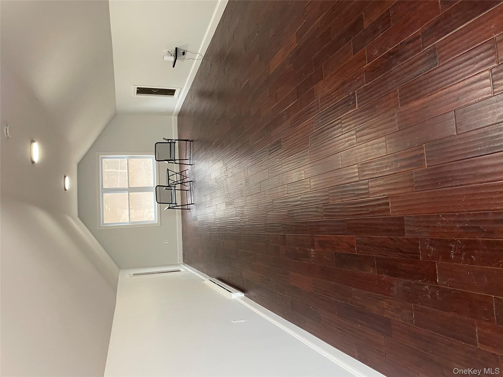 325 Hasbrouck Road Woodbourne, NY 12788 - Photo 8 of 14 a view of empty room with wooden floor and window