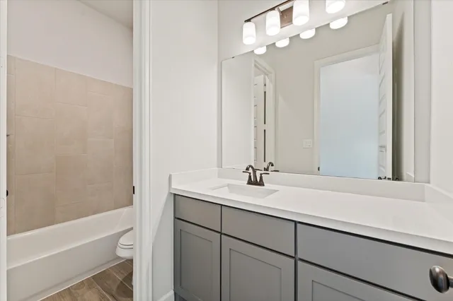a bathroom with a sink a vanity and a mirror