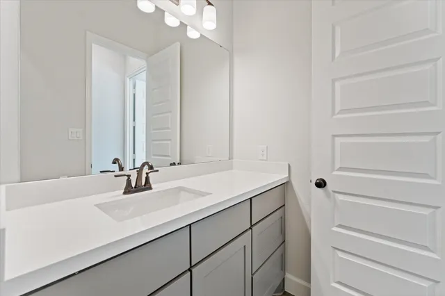 a bathroom with a sink vanity and a mirror