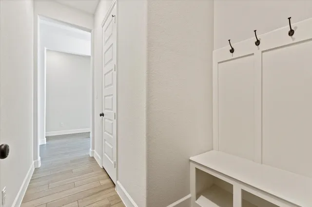 a view of a hallway with wooden floor