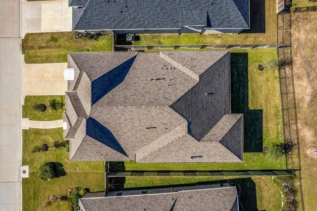 an aerial view of a house with a swimming pool