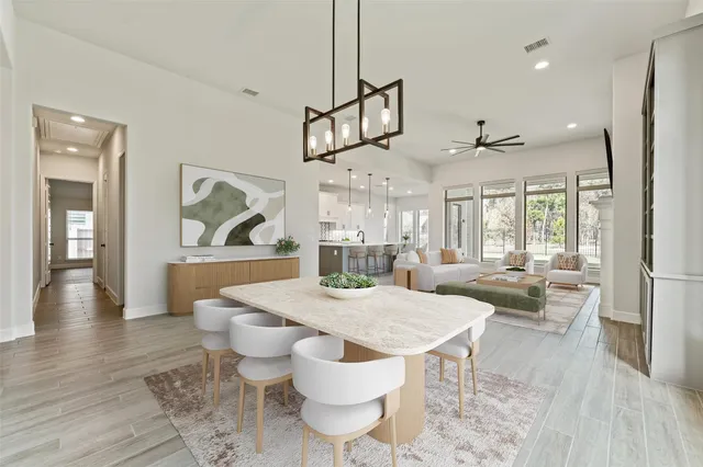 a view of a dining room with furniture wooden floor and chandelier