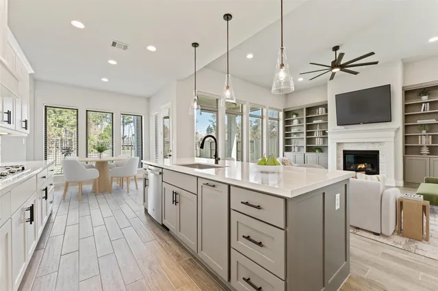 a open kitchen with stainless steel appliances granite countertop a lot of counter space and a wooden floors