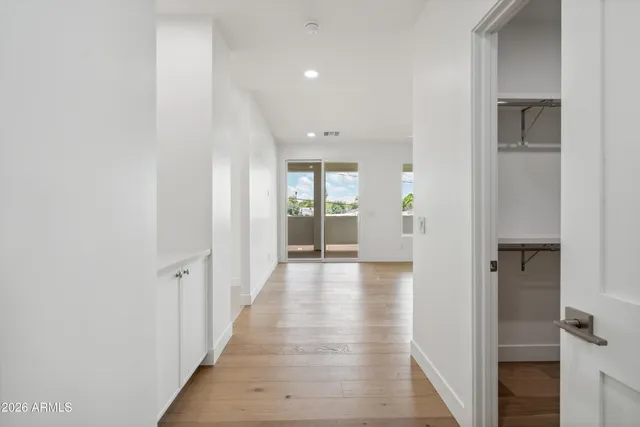 a spacious bathroom with a double vanity sink mirror and bathtub