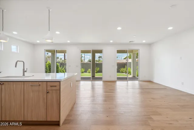 a living room with furniture a kitchen view and a kitchen view