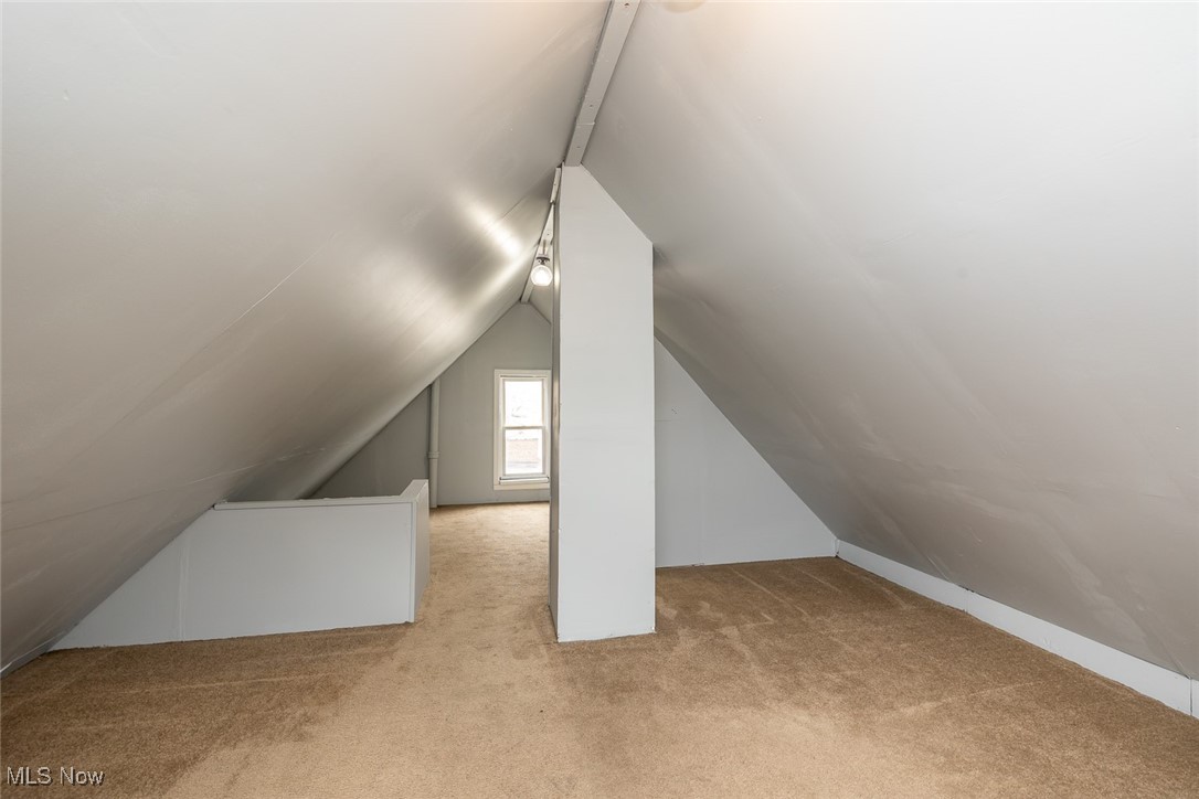 15328 Shiloh Road Cleveland, OH 44110 - Photo 9 of 27 Additional living space featuring light colored carpet and vaulted ceiling