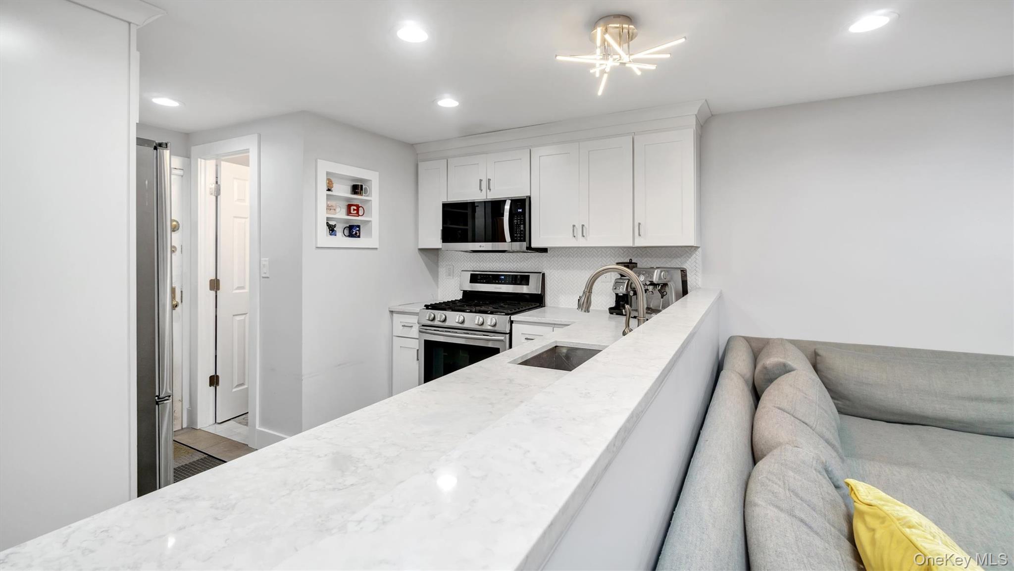 19 Barstow Road, Unit G Great Neck, NY 11021 - Photo 16 of 36 a bedroom with a bed and a television