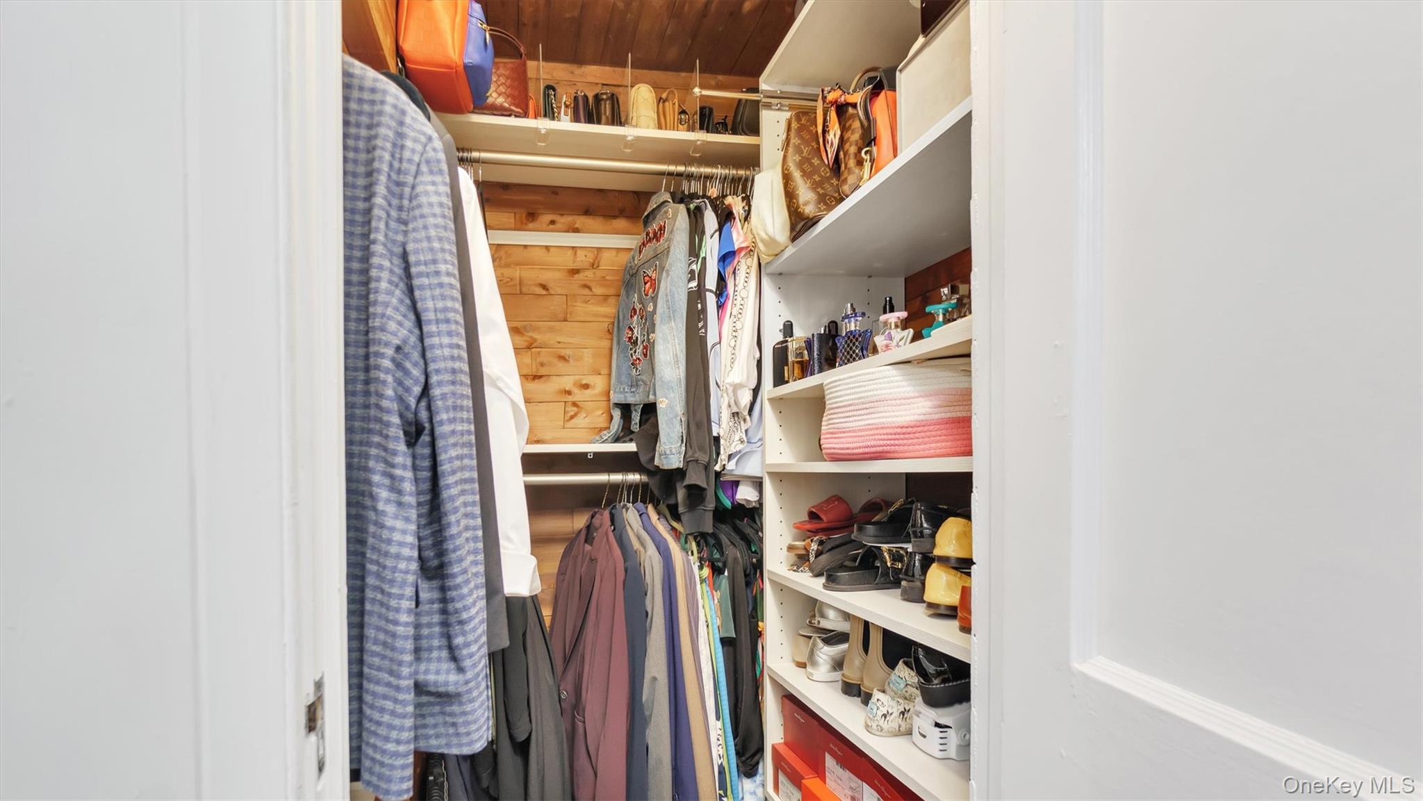 19 Barstow Road, Unit G Great Neck, NY 11021 - Photo 24 of 36 a view of walk in closet with clothes and shoes