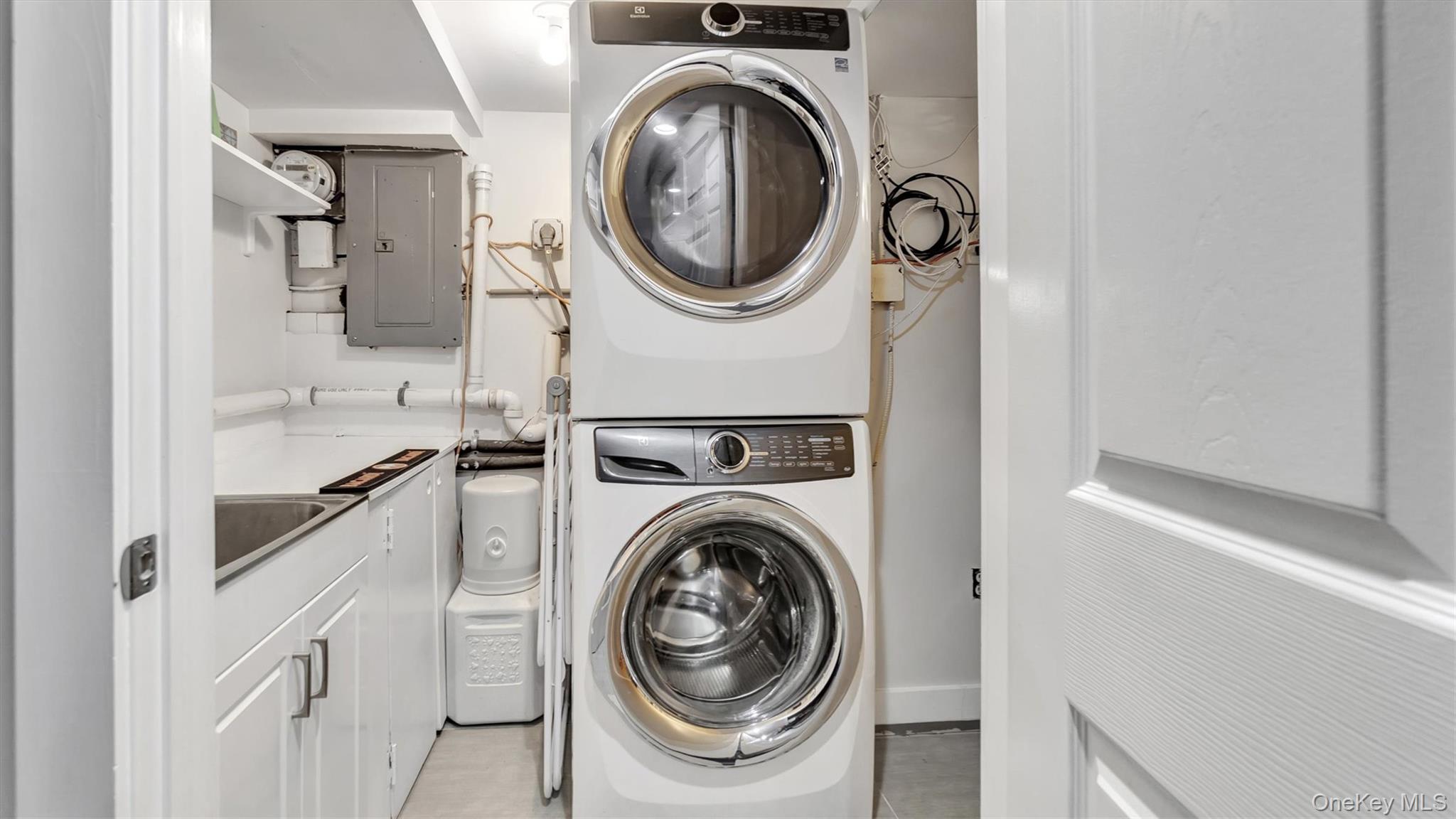 19 Barstow Road, Unit G Great Neck, NY 11021 - Photo 30 of 36 a utility room with sink dryer and washer