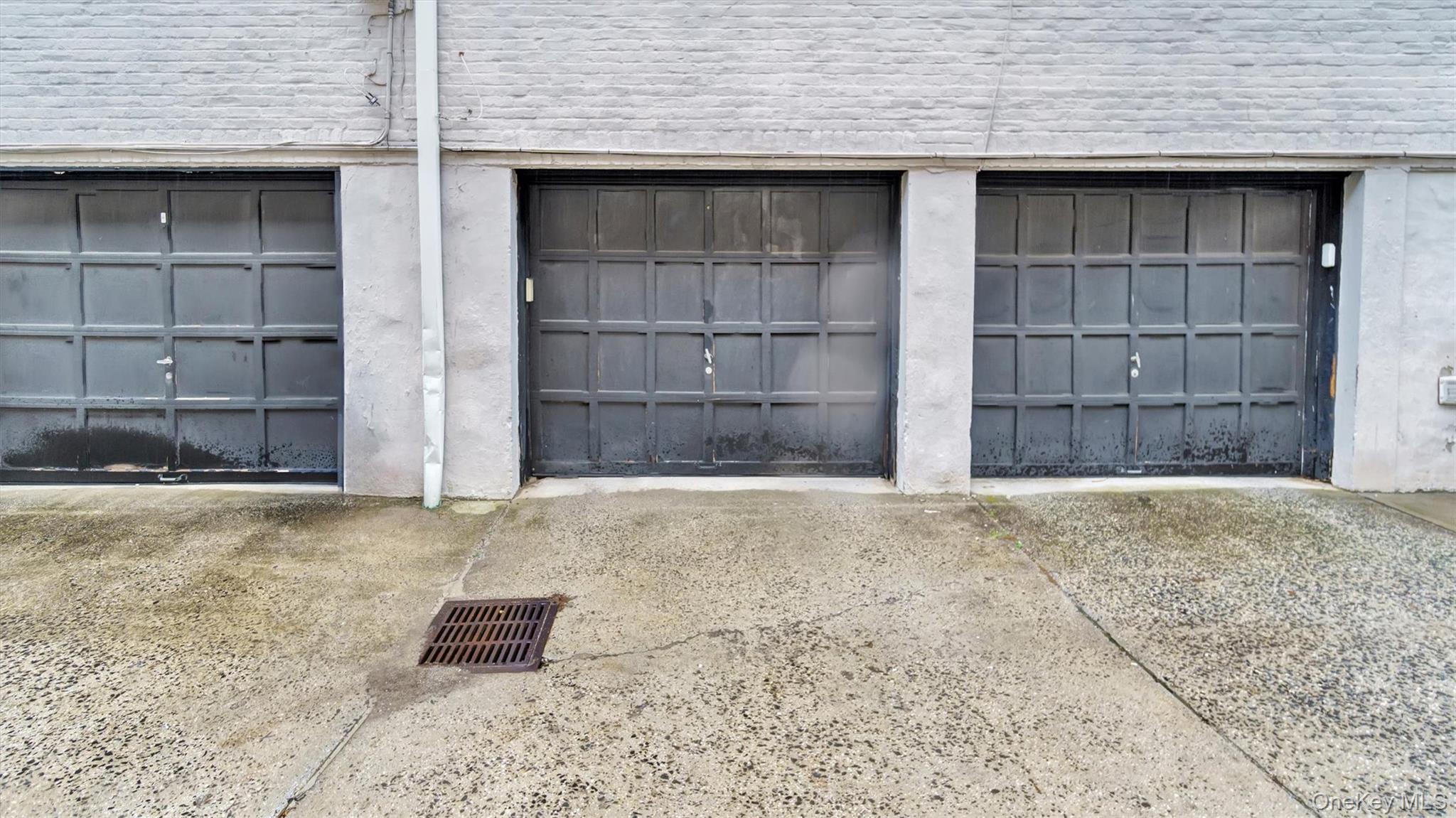 19 Barstow Road, Unit G Great Neck, NY 11021 - Photo 10 of 36 a front view of a house with a yard and garage