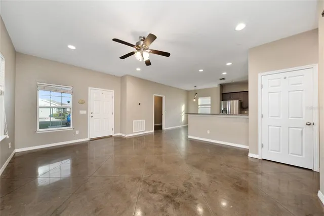 a kitchen with stainless steel appliances granite countertop a stove top oven a sink and a refrigerator