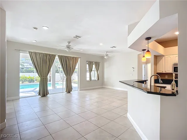 a view of a kitchen with furniture and a large window