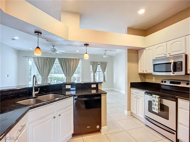 a kitchen with stainless steel appliances a stove sink and cabinets