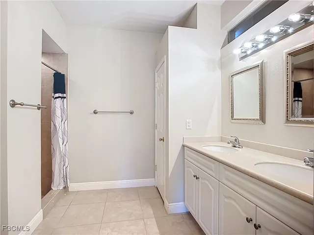 a spacious bathroom with a sink and a mirror
