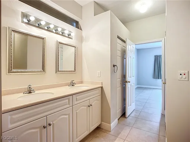 a spacious bathroom with a double vanity sink and a mirror
