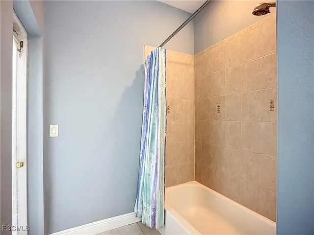 a bathroom with a bathtub and shower