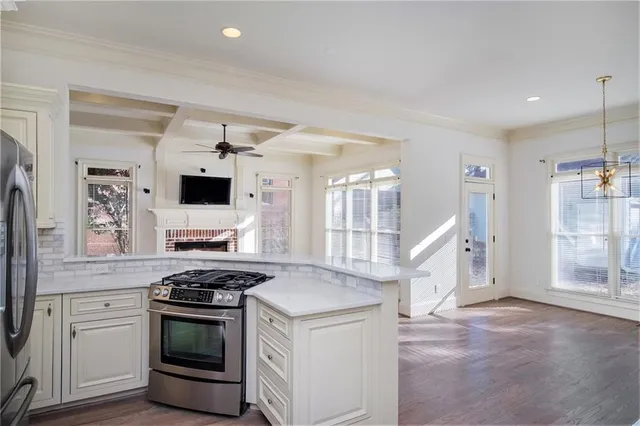 a kitchen with white cabinets and appliances