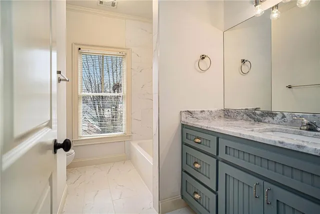 a bathroom with a granite countertop sink a mirror and a