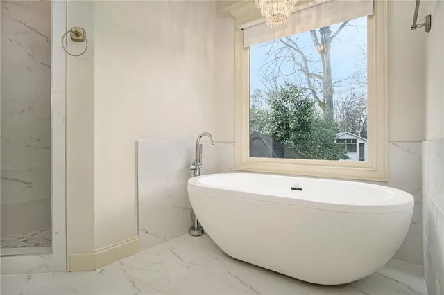 a white bath tub sitting next to a window