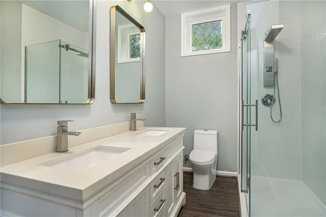 a bathroom with a sink toilet and shower