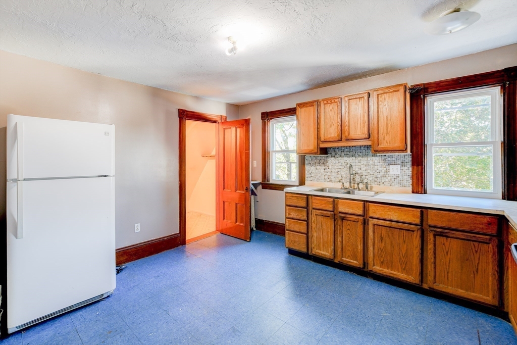 120 Graham Street Gardner, MA 01440 - Photo 29 of 37 a kitchen with stainless steel appliances granite countertop a refrigerator a sink dishwasher a stove and a refrigerator with wooden floor