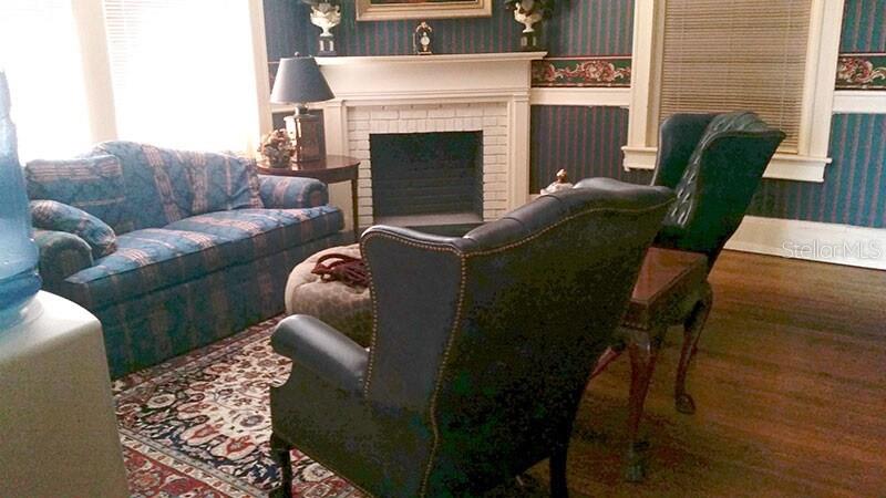 250 East Park Avenue Lake Wales, FL 33853 - Photo 12 of 15 a living room with furniture and a fireplace