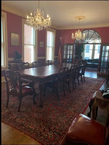 a view of a dining room with furniture and chandelier