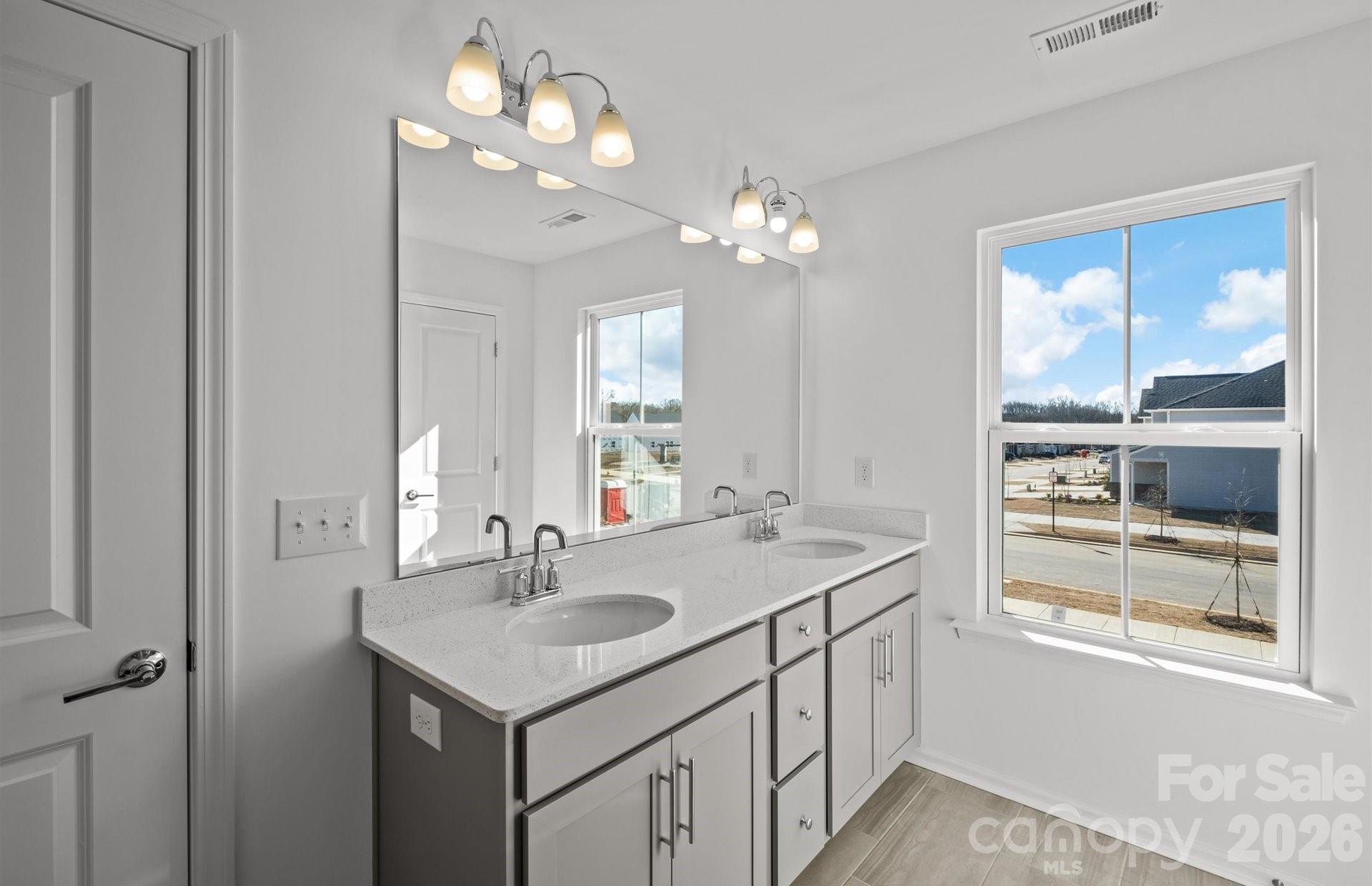 3605 Edisto Place Monroe, NC 28110 - Photo 12 of 17 a bathroom with a sink a vanity and a mirror