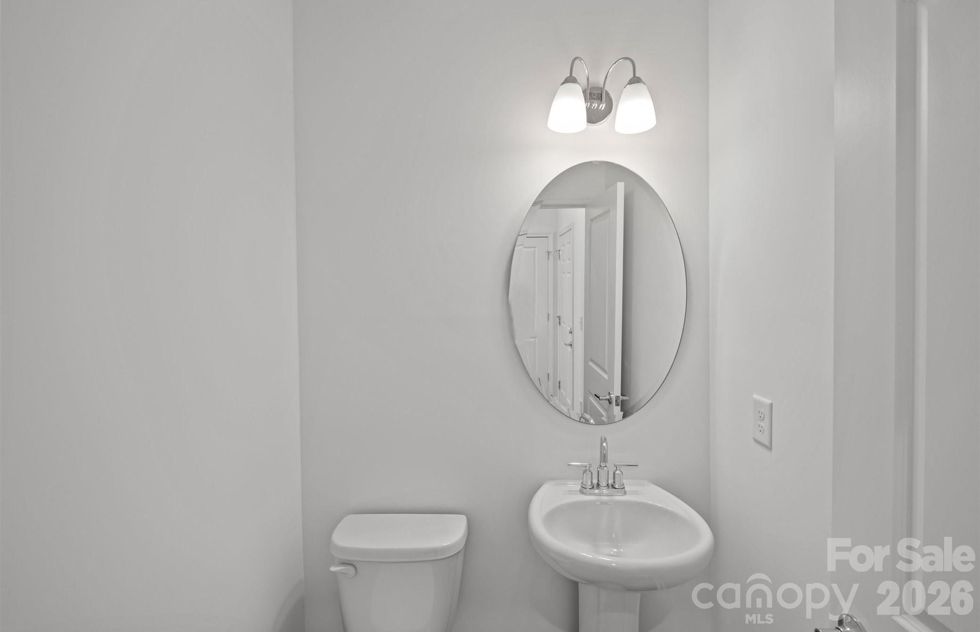 3605 Edisto Place Monroe, NC 28110 - Photo 7 of 17 a bathroom with a toilet a sink and a mirror