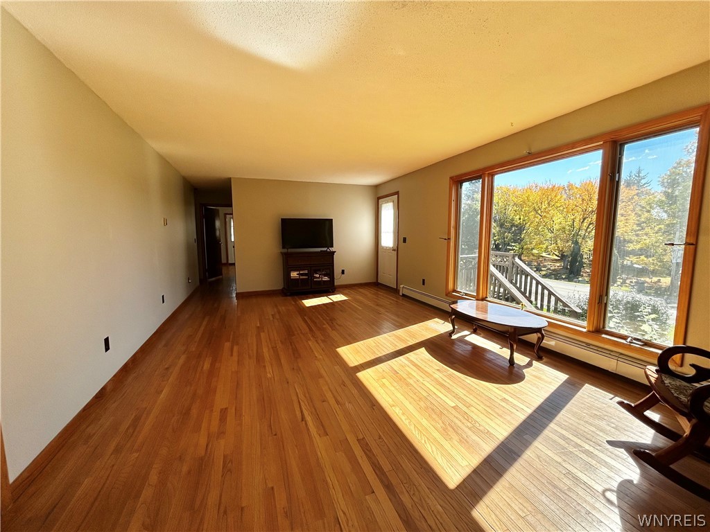 3564 Roszyk Hill Road Machias, NY 14101 - Photo 4 of 20 Rich hardwood flooring anchors this living space,