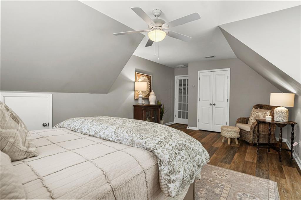509 Crested Hawk Ridge Canton, GA 30114 - Photo 42 of 89 a bedroom with a bed and wooden floor