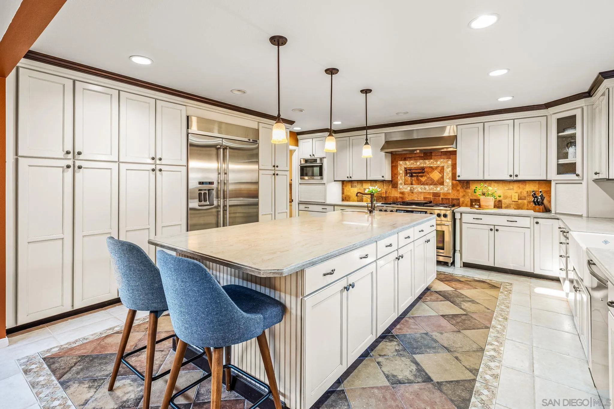 2260 East Mission Road Fallbrook, CA 92028 - Photo 12 of 38 a kitchen with stainless steel appliances granite countertop a stove top oven a sink a dining table and chairs