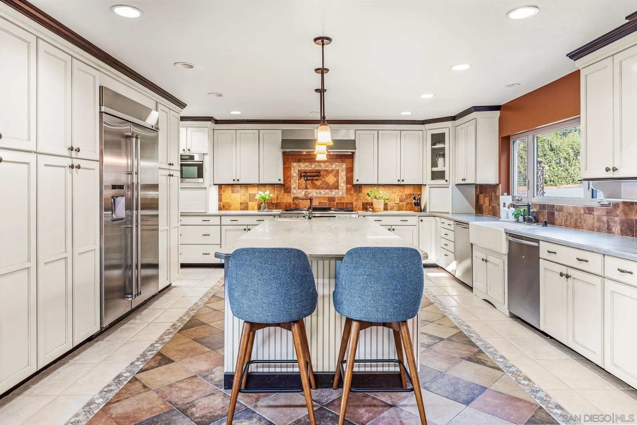 2260 East Mission Road Fallbrook, CA 92028 - Photo 13 of 38 a kitchen with stainless steel appliances granite countertop a stove a refrigerator a sink dishwasher a dining table and chairs with wooden floor
