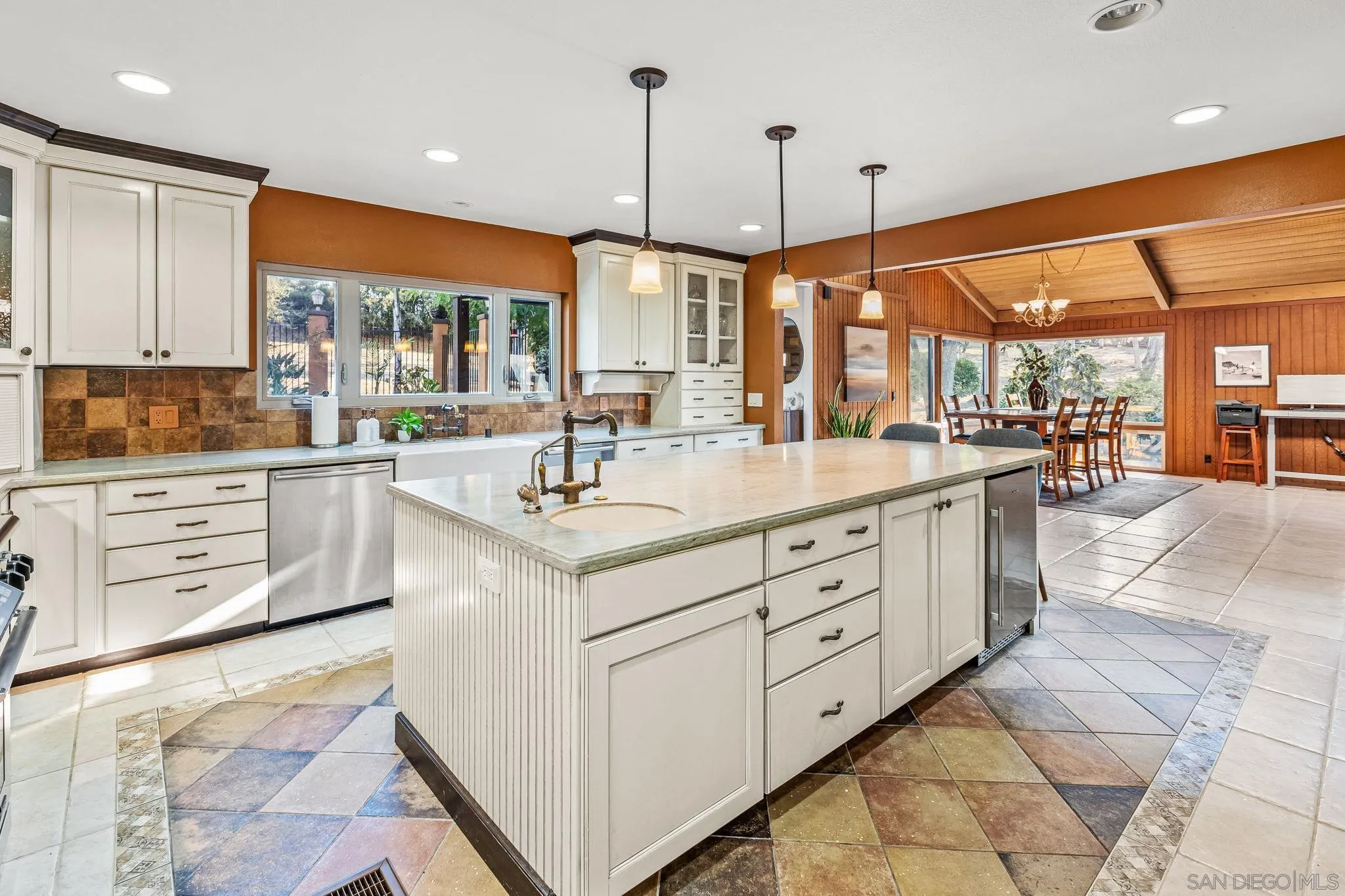2260 East Mission Road Fallbrook, CA 92028 - Photo 15 of 38 a kitchen with kitchen island granite countertop a sink a counter top space appliances and cabinets