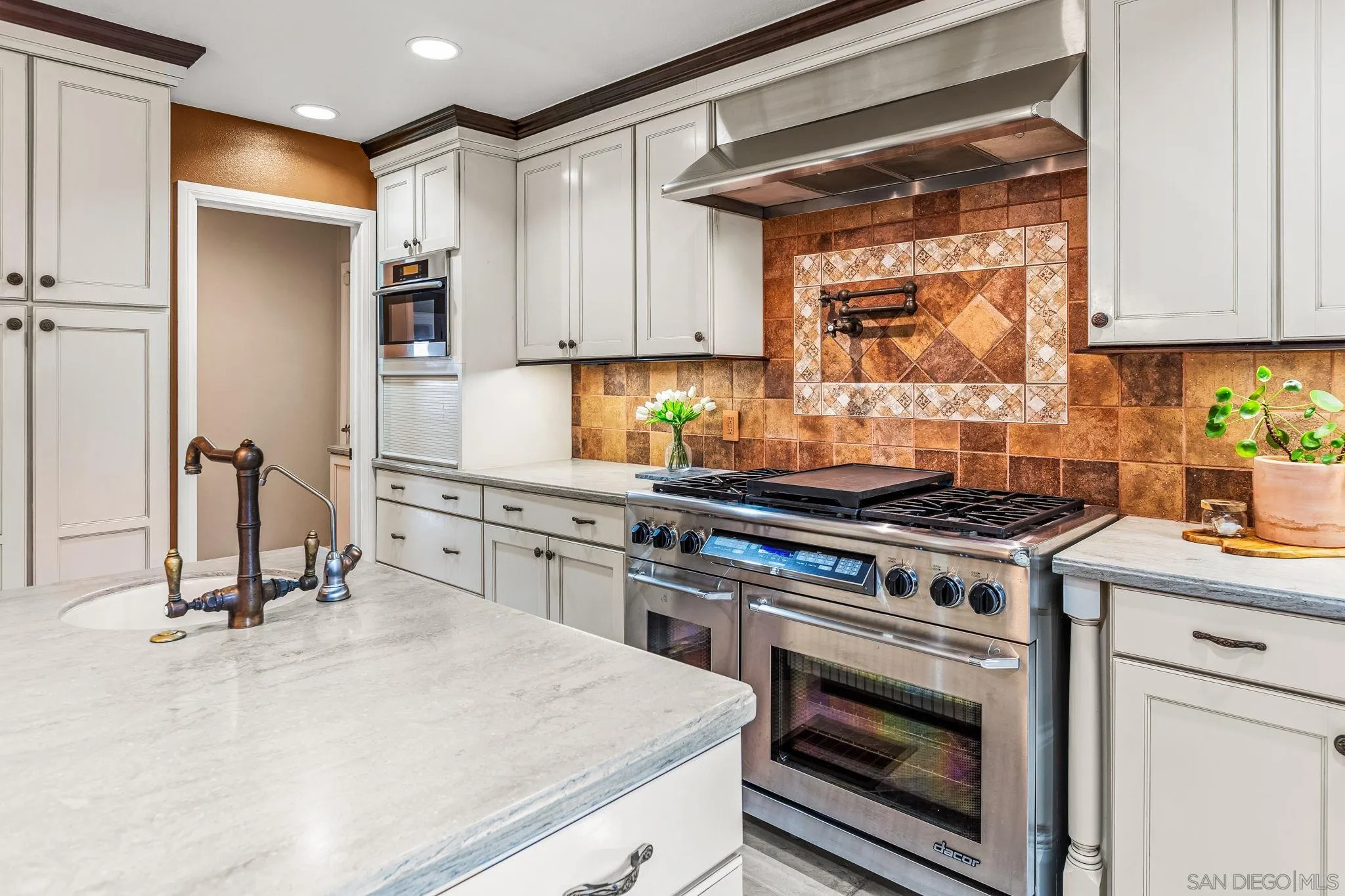 2260 East Mission Road Fallbrook, CA 92028 - Photo 16 of 38 a kitchen with stainless steel appliances a stove a sink and a refrigerator