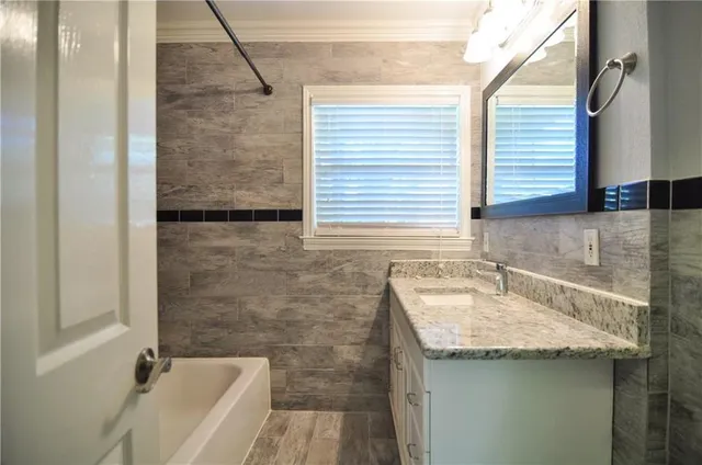 a bathroom with a sink and a bathtub