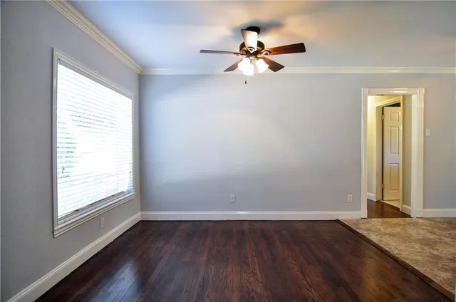 a view of a room with wooden floor and window