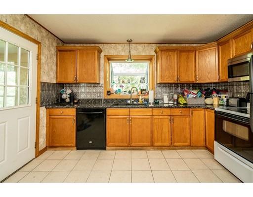 17 Babb Road Southwick, MA 01077 - Photo 4 of 20 a kitchen with stainless steel appliances granite countertop a stove a sink and a microwave