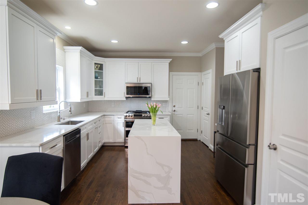 9311 Tabriz Point Raleigh, NC 27614 - Photo 2 of 25 Hubba hubba! This drool worthy kitchen is a chef's dream come true with top of the line appliances and waterfall edge island.