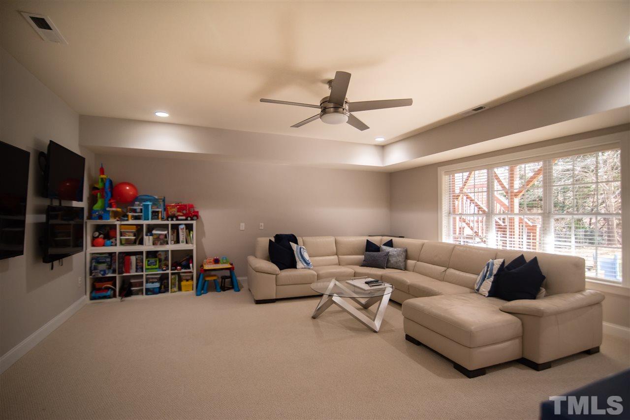 9311 Tabriz Point Raleigh, NC 27614 - Photo 19 of 25 Make it your game room, second family room or playroom - there are so many ways to use this space! Steps from the backyard, you'll love having access to this walk-out basement.