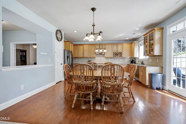 a kitchen with stainless steel appliances granite countertop a sink a stove and cabinets
