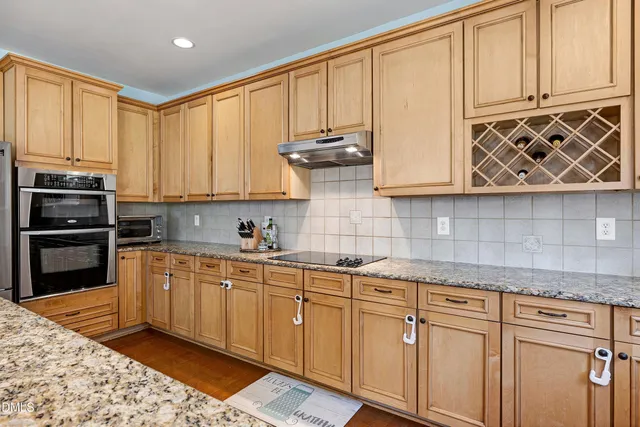 an empty room with closet and mirrors