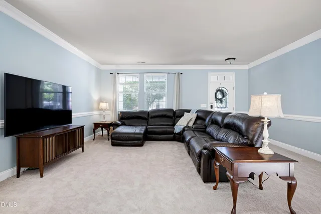 a view of a livingroom with furniture and staircase