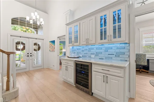 a view of a dining room with furniture and a chandelier