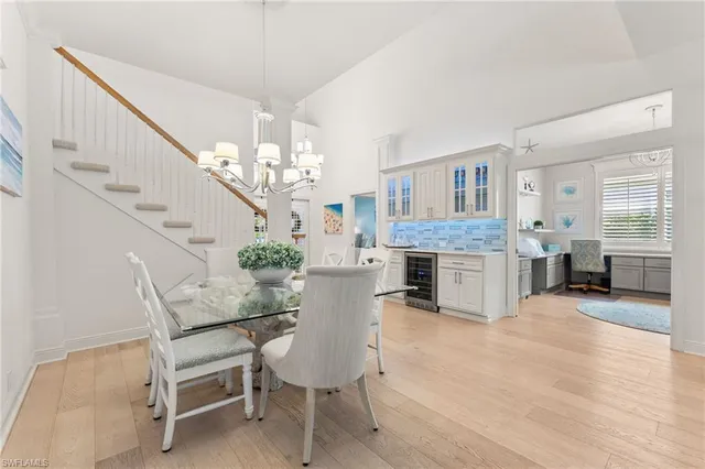 a view of a dining room with furniture and chandelier