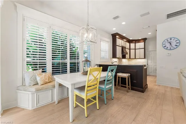 a kitchen with stainless steel appliances granite countertop a lot of cabinets and wooden floor