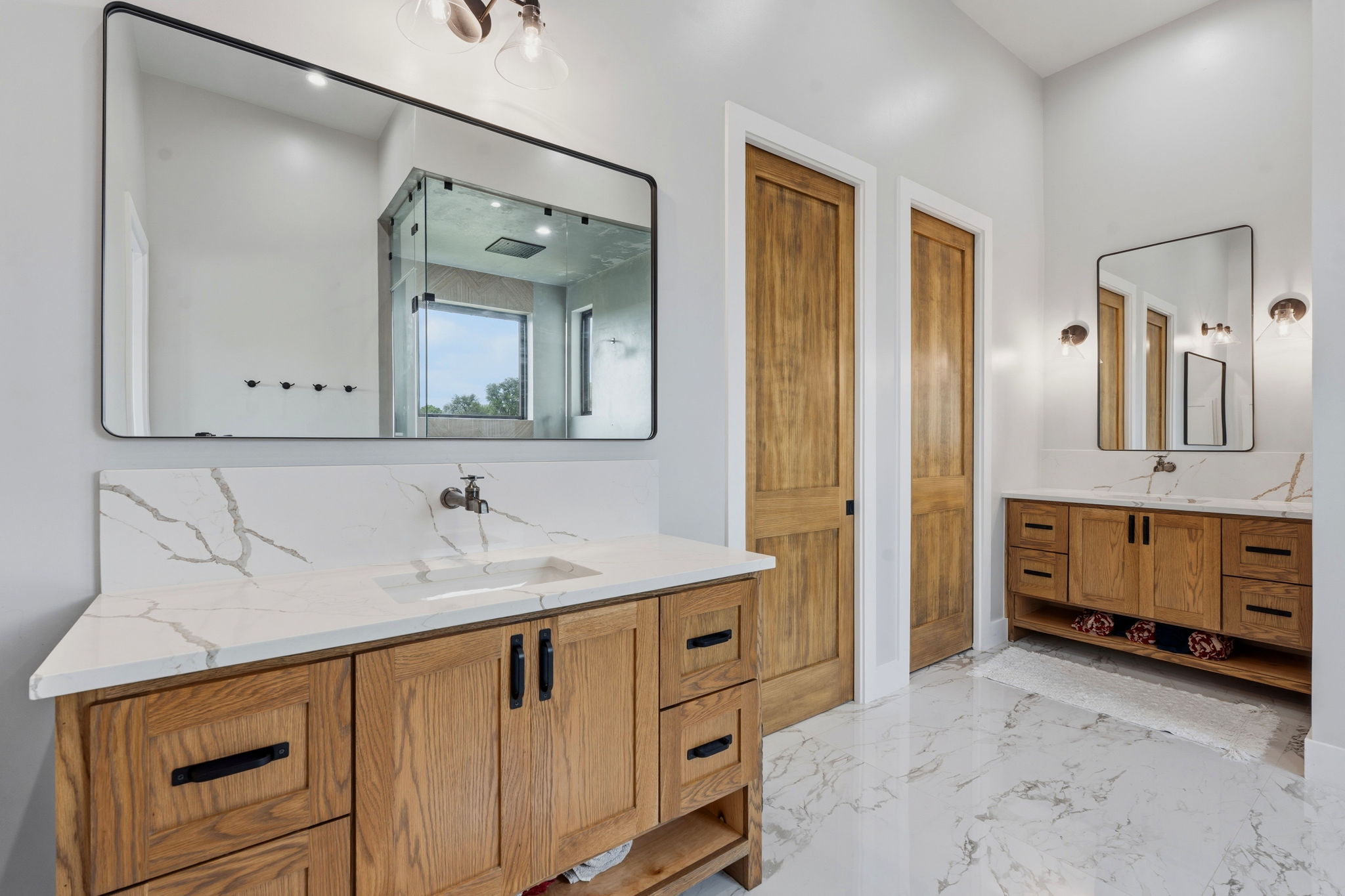 194 Placid Way Spring Branch, TX 78070 - Photo 13 of 37 Dual wood-finish vanities with quartz countertops and integrated sinks