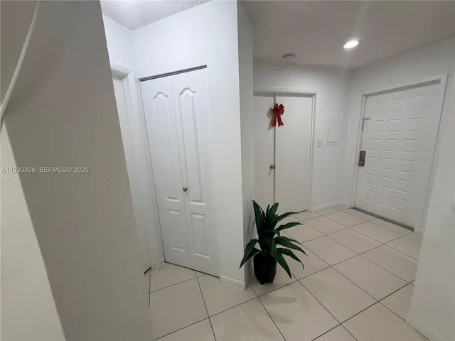 a bathroom with a shower and a plant in it